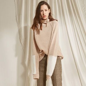 Beige sweater with white leather patch
